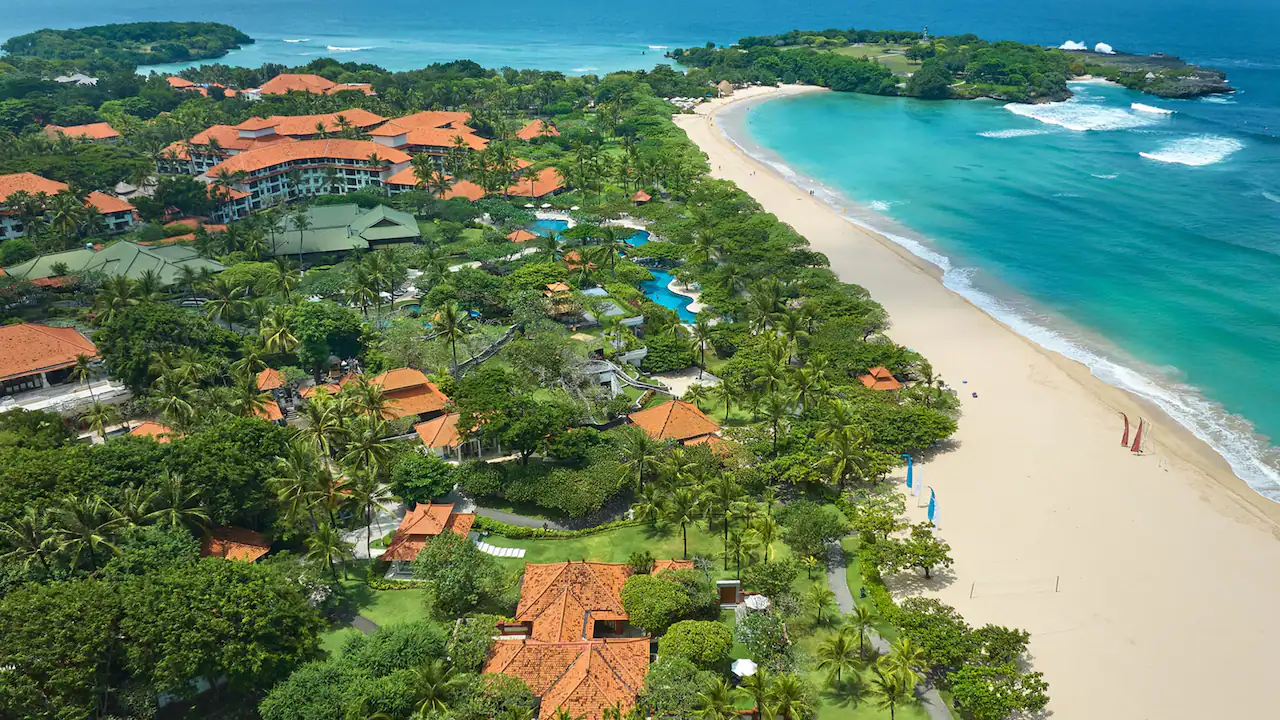Aerial view of Grand Hyatt Bali with winding pools and long beachfront in Nusa Dua