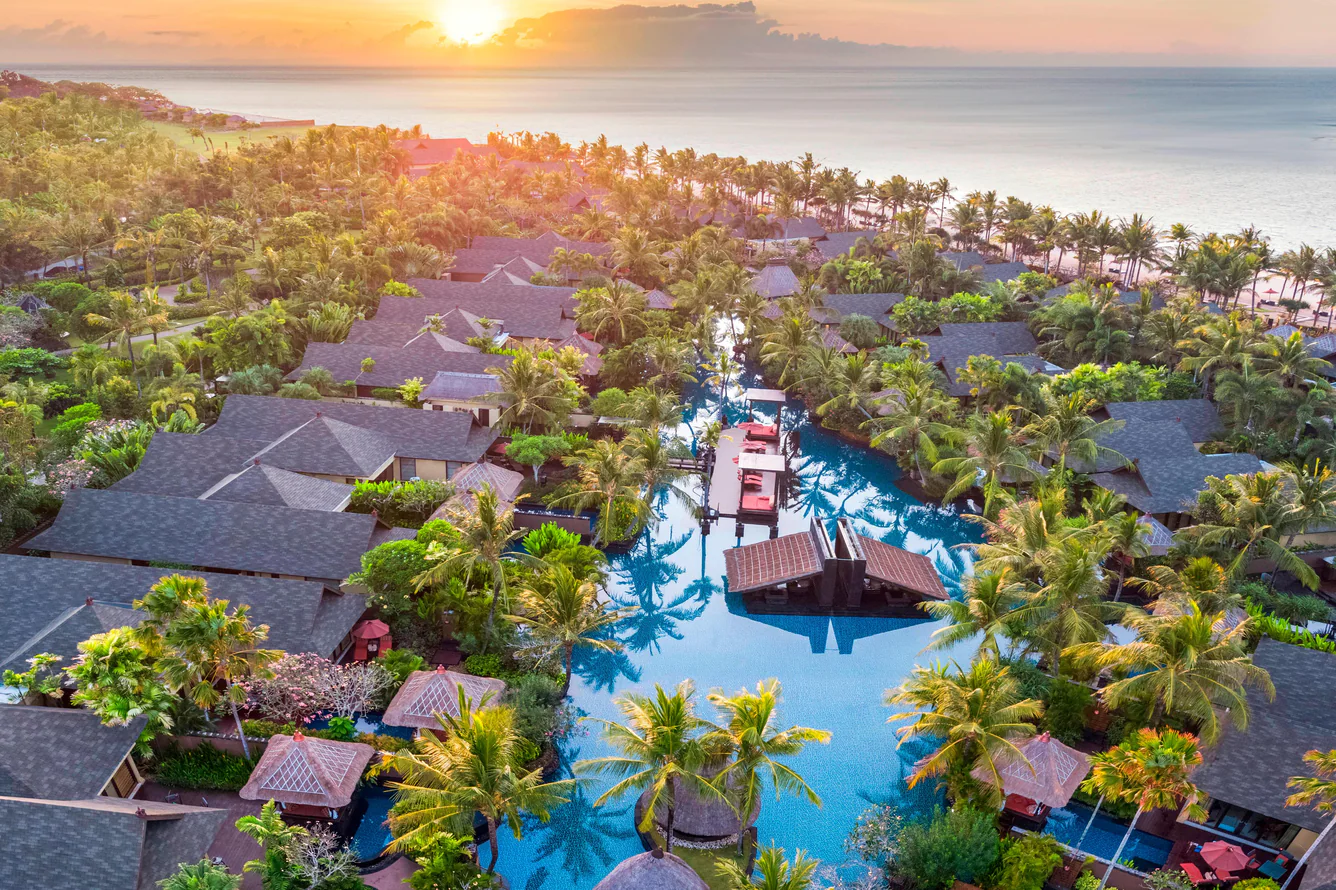 Sunset aerial view of private villas and lagoon pool at The St Regis Bali Resort in Nusa Dua