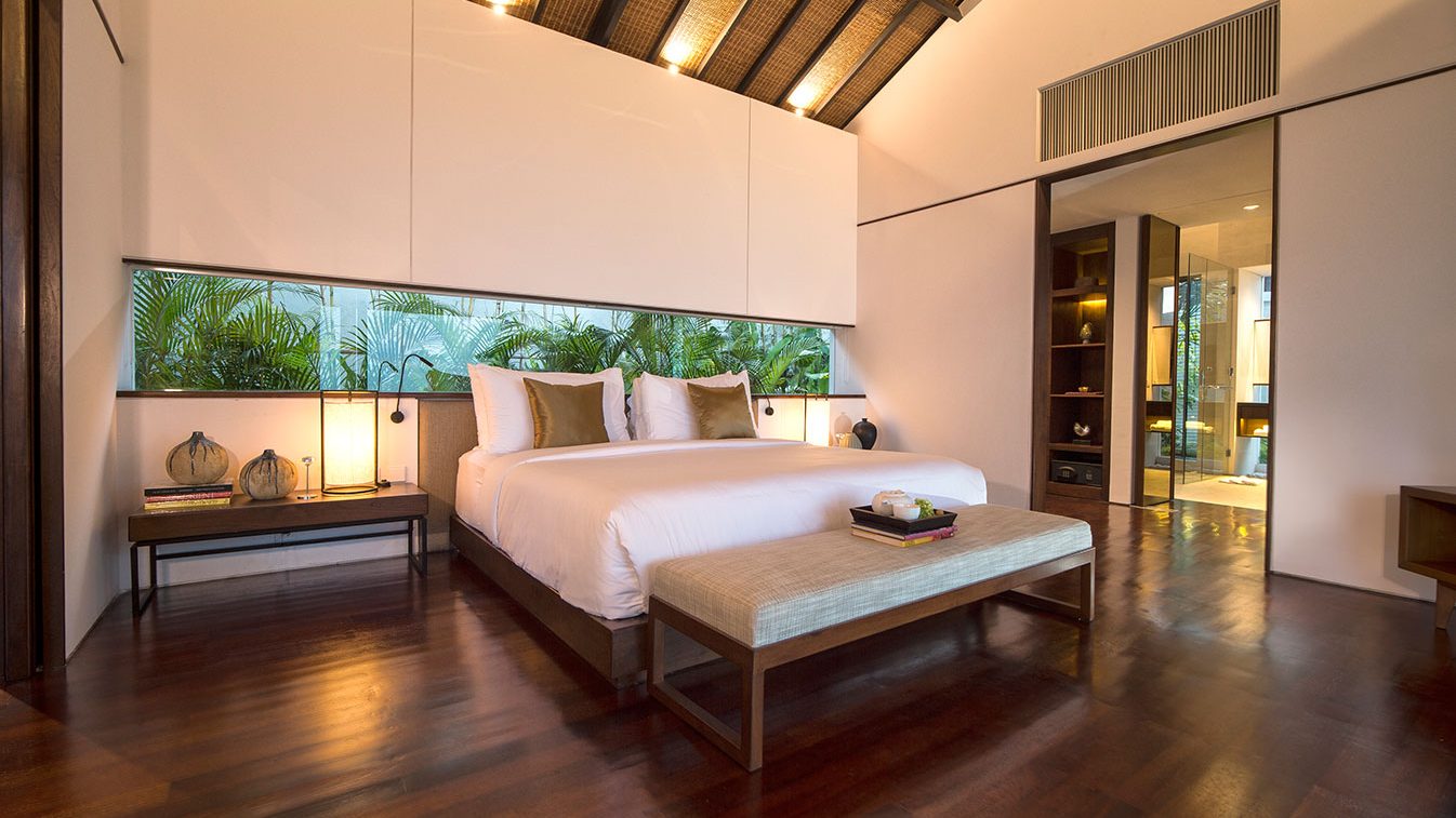 Spacious master bedroom at Alta Vista Mountain Villa Bali with king bed wood floors and garden window