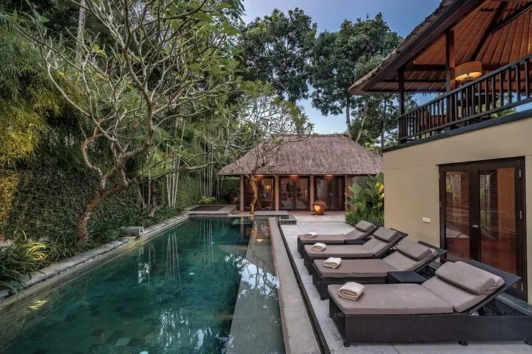 Private pool villa with sun loungers and tropical garden at Kayumanis Nusa Dua in Bali