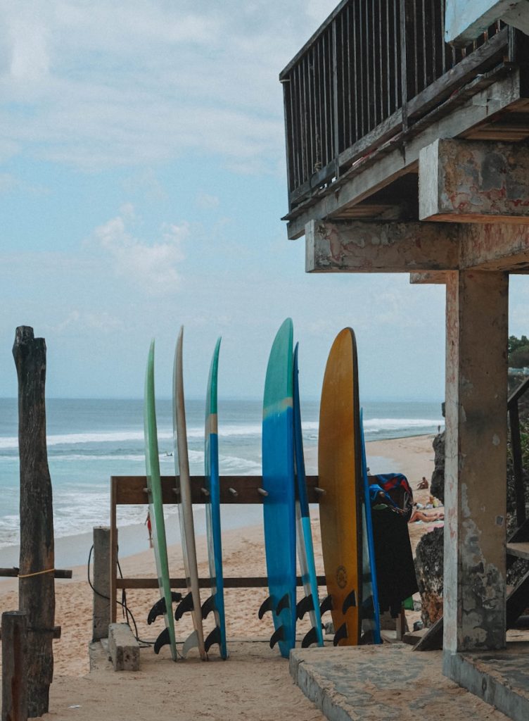 a group of surfboards sitting on top of Uluwatu sandy beach