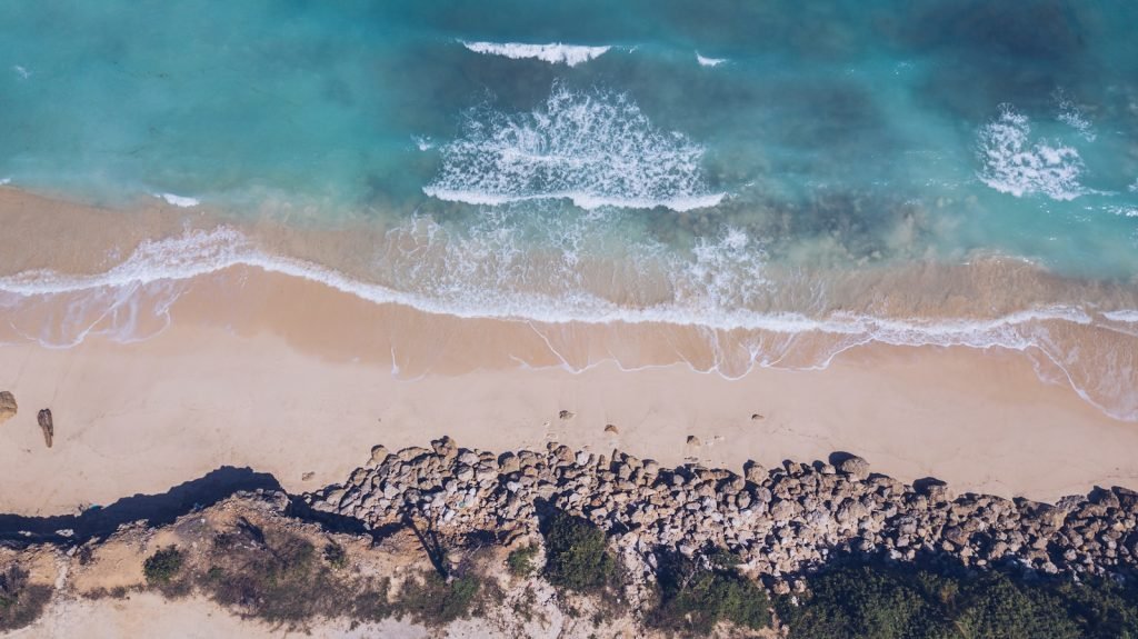 aerial photo of sea shore during daytime in green bowl beach
