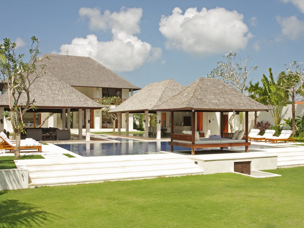 Villa Asante Echo Beach white Bali style villa with central swimming pool open pavilions and manicured lawn