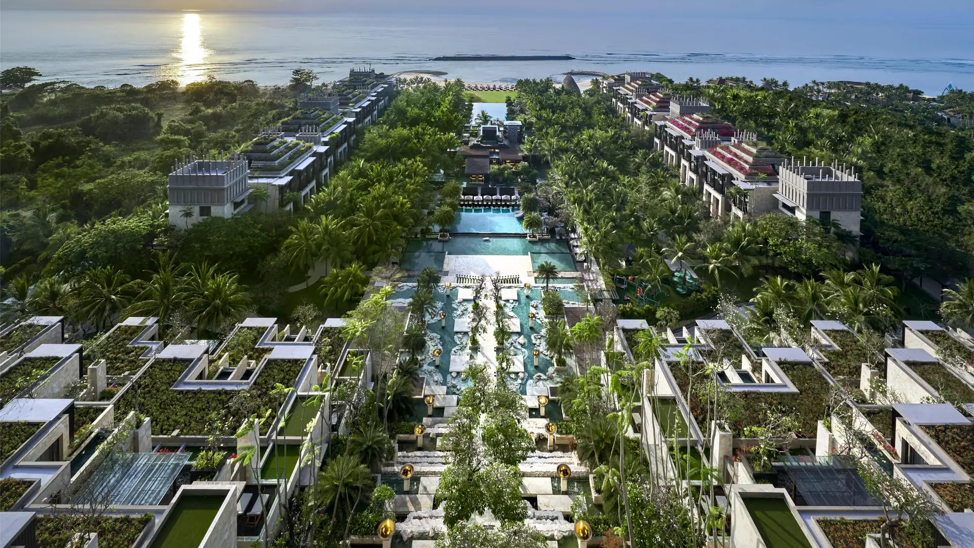 Aerial view of The Apurva Kempinski Bali with its tiered architecture, tropical gardens and oceanfront pools